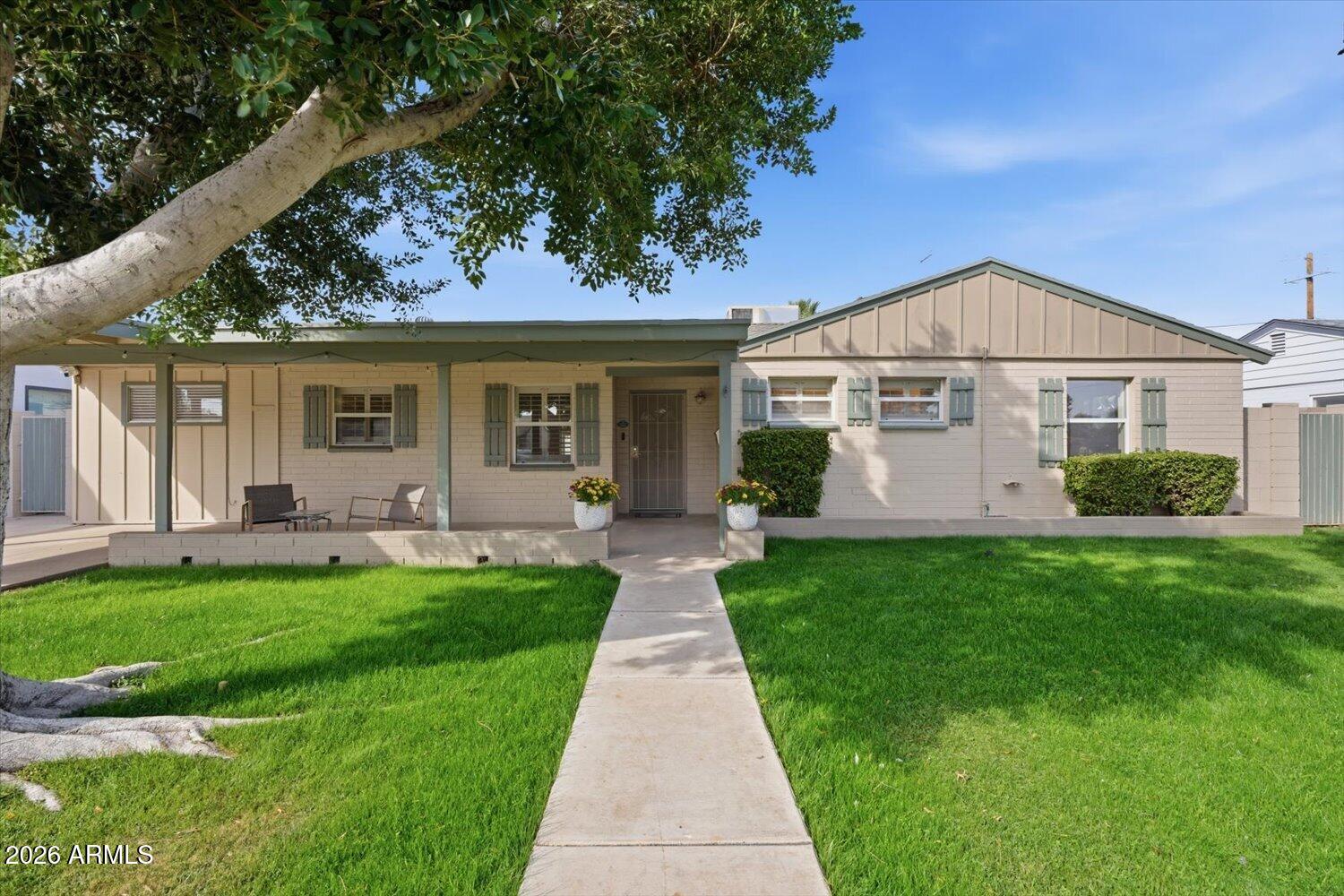 934 East Berridge Lane Phoenix, AZ 85014 - Photo 1 of 29 a front view of a house with a garden