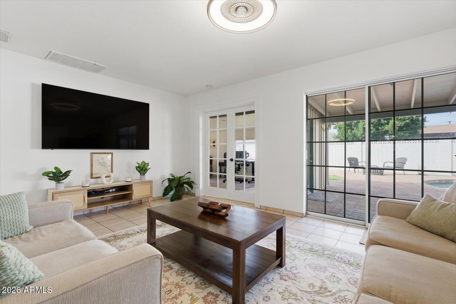 934 East Berridge Lane Phoenix, AZ 85014 - Photo 12 of 29 a living room with furniture and a flat screen tv