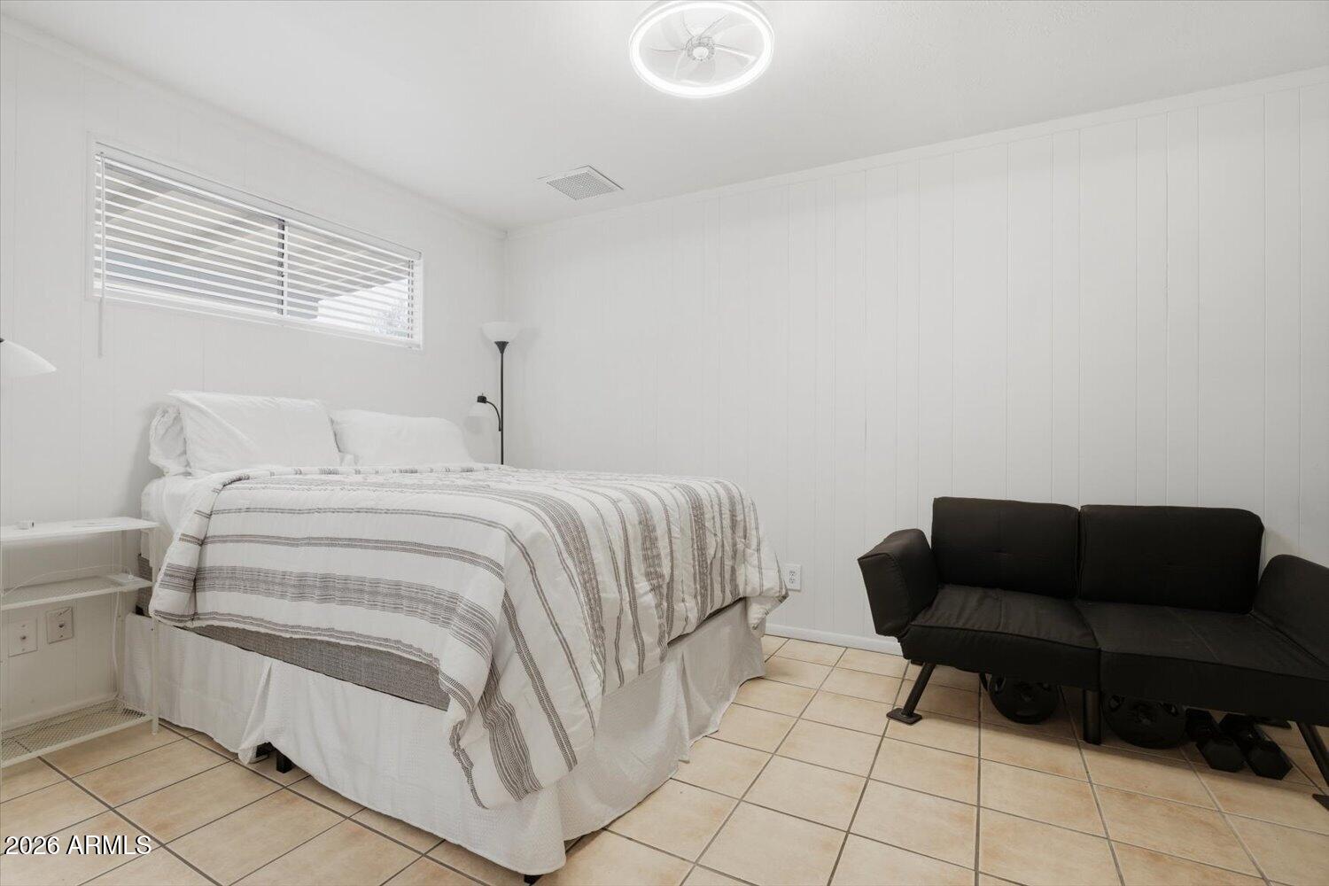 934 East Berridge Lane Phoenix, AZ 85014 - Photo 18 of 29 a bedroom with a bed and a couch