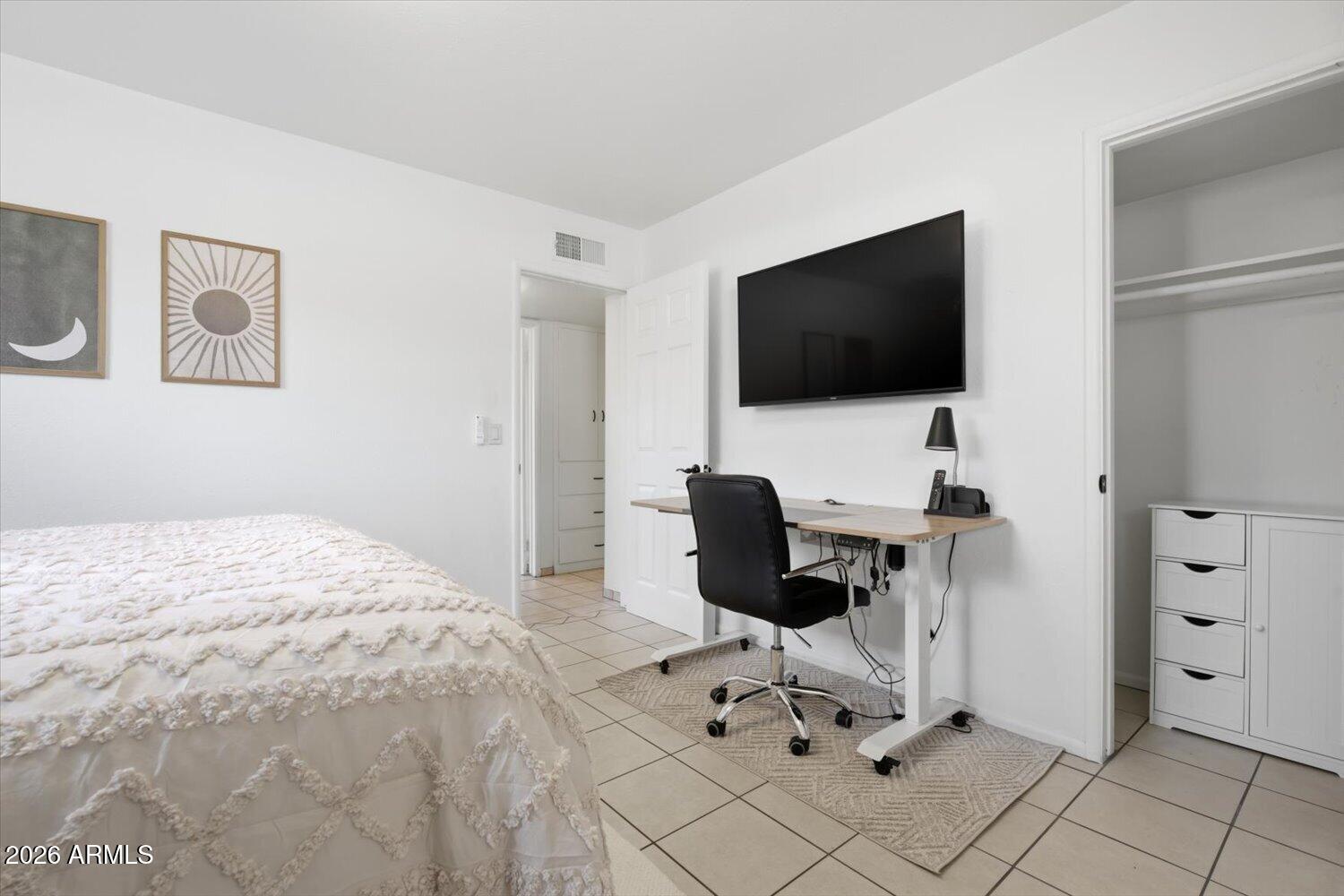 934 East Berridge Lane Phoenix, AZ 85014 - Photo 20 of 29 a bedroom with a bed and a flat screen tv