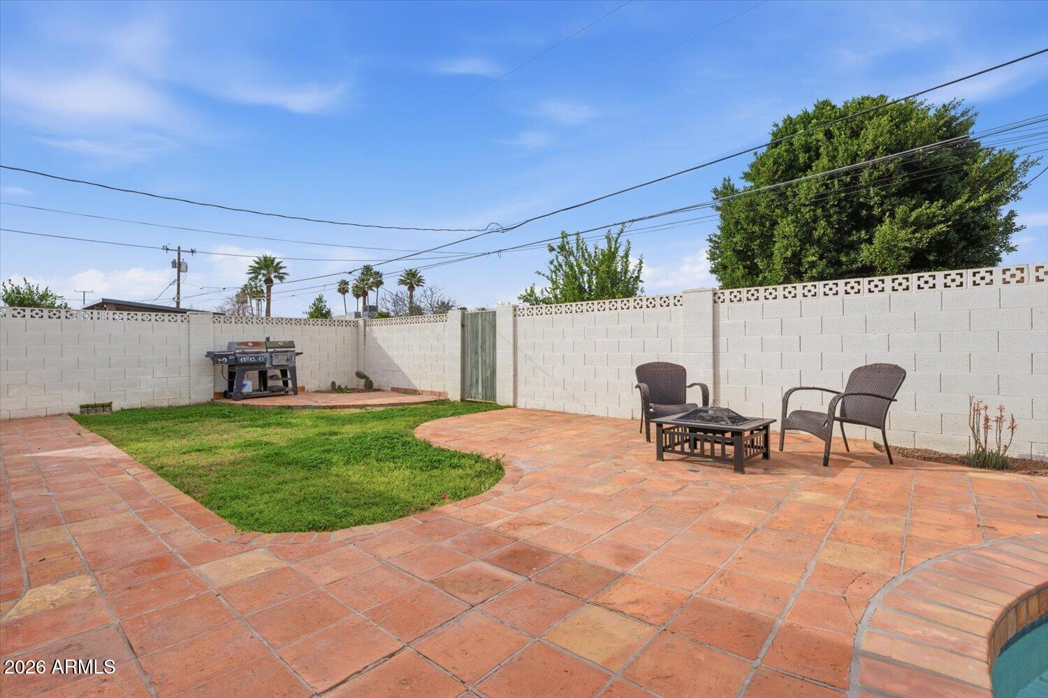 934 East Berridge Lane Phoenix, AZ 85014 - Photo 27 of 29 a view of a patio with a table and chairs and potted plants