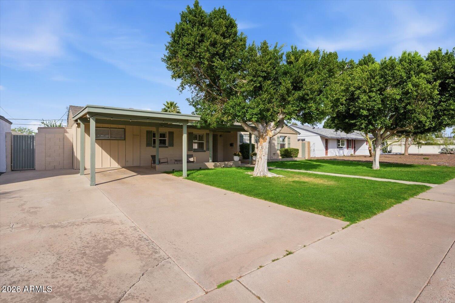 934 East Berridge Lane Phoenix, AZ 85014 - Photo 3 of 29 a front view of a house with a yard and garage