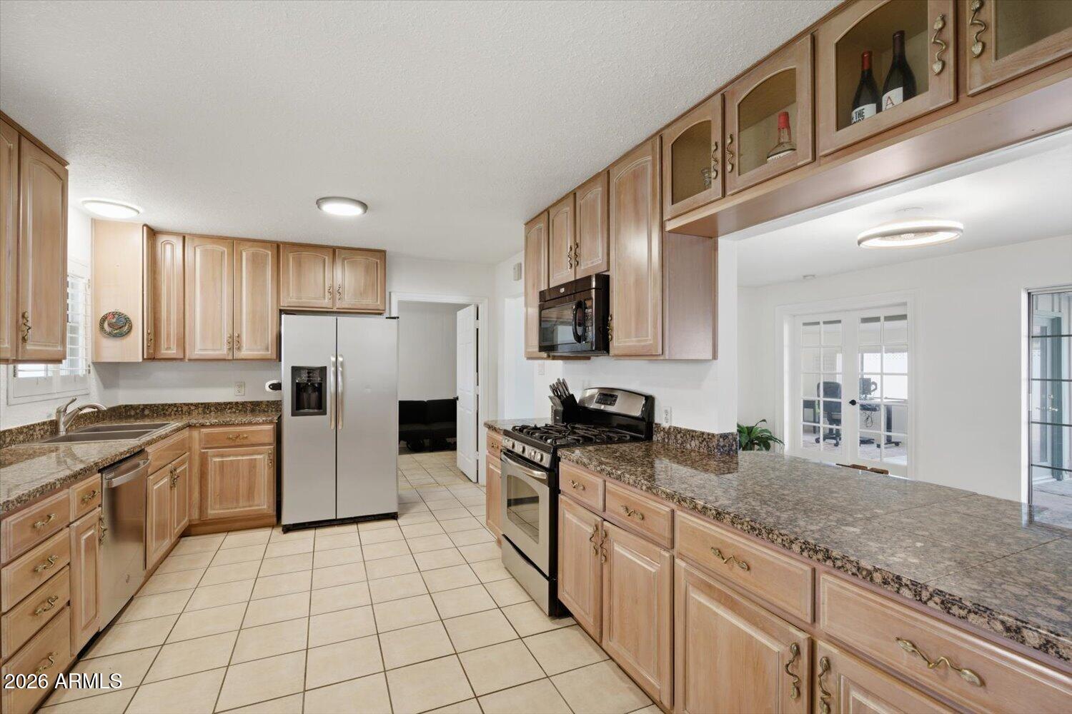 934 East Berridge Lane Phoenix, AZ 85014 - Photo 6 of 29 a kitchen with stainless steel appliances granite countertop a stove a sink and a refrigerator