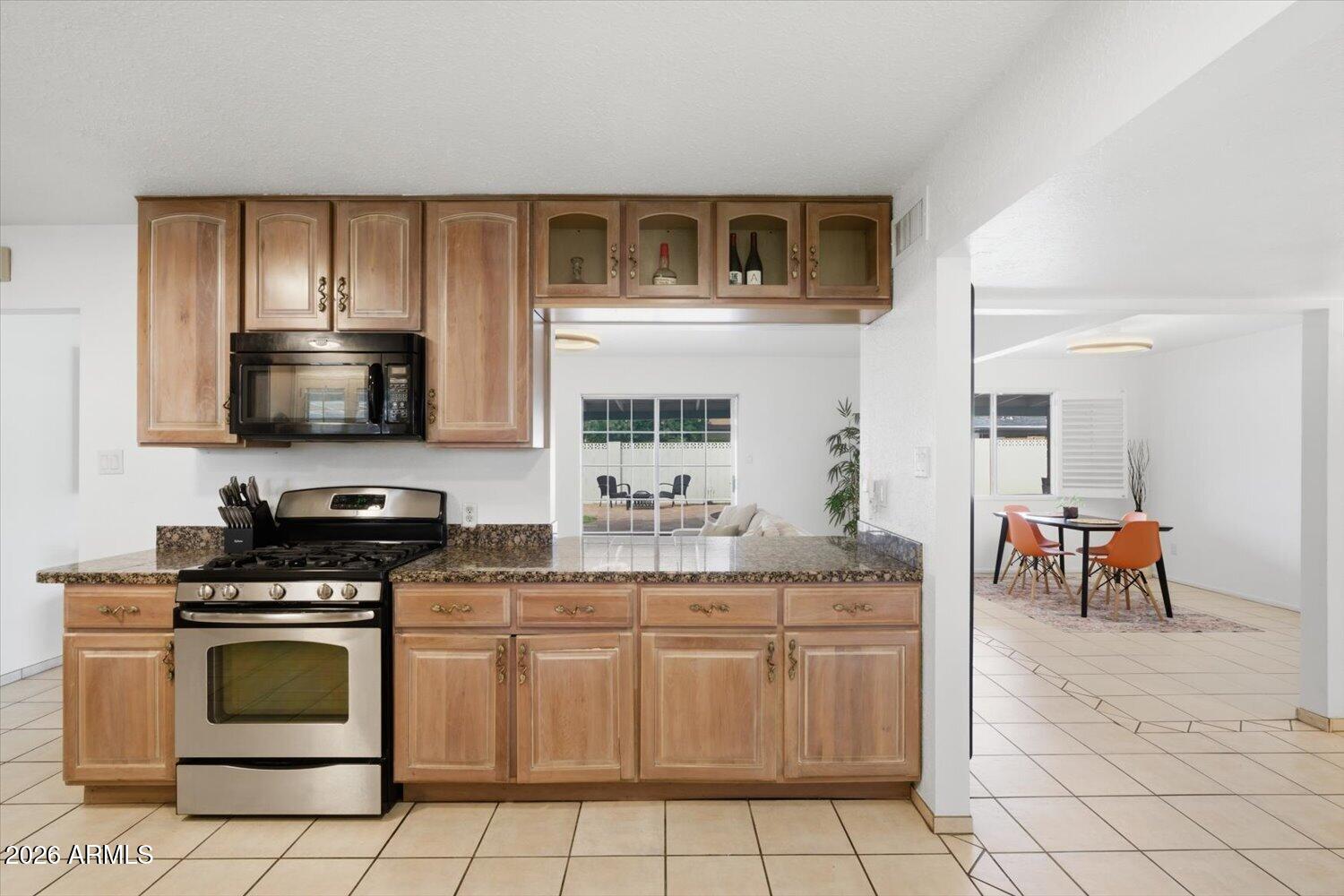 934 East Berridge Lane Phoenix, AZ 85014 - Photo 7 of 29 a kitchen with stainless steel appliances a stove a sink and a microwave