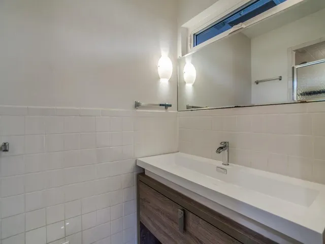 a bathroom with a sink and vanity