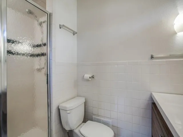 a bathroom with a toilet and shower