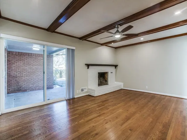 wooden floor in an empty room with a fireplace