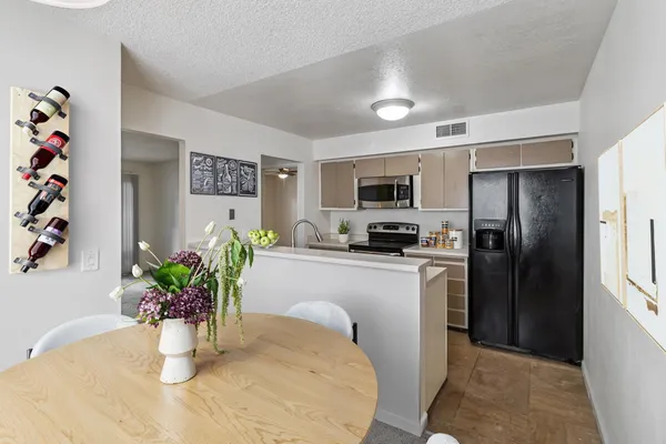 a kitchen with a refrigerator and a stove