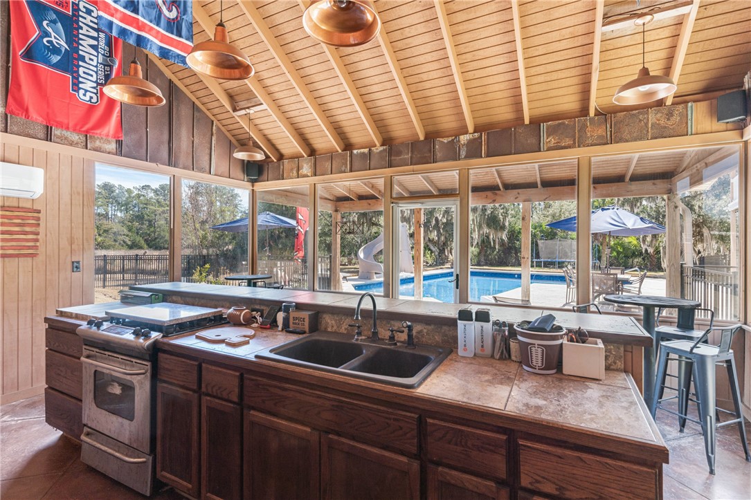 210 Sandpiper Road Brunswick, GA 31523 - Photo 36 of 54 Kitchen in Pool House w/fridge and gas line to gas stove/oven
