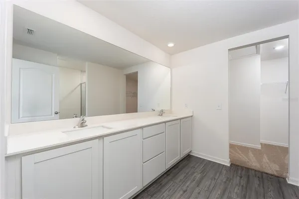 a bathroom with a double vanity sink and mirror
