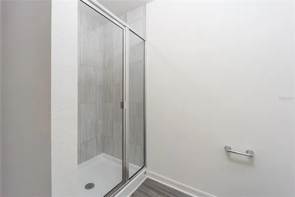 a bathroom with a glass shower door