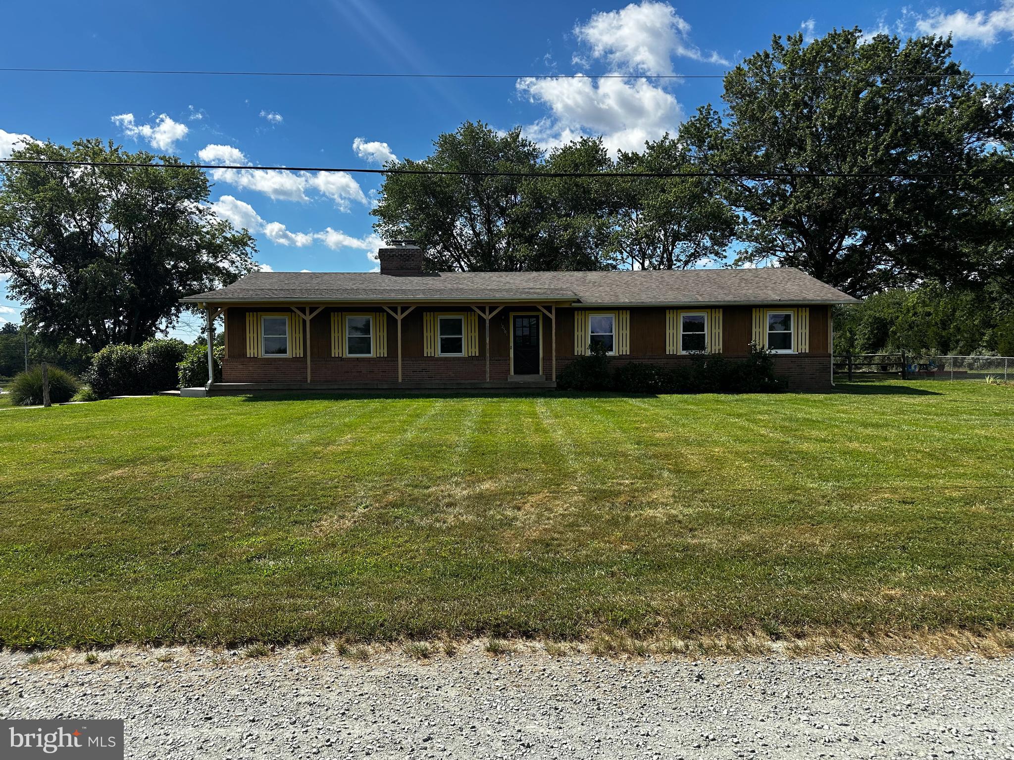 a front view of house with yard and lake view