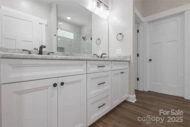 a bathroom with a granite countertop sink mirror and vanity