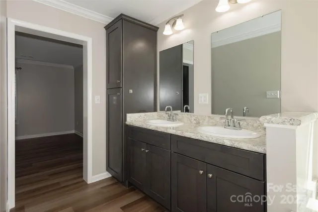 a bathroom with a double vanity sink and a mirror