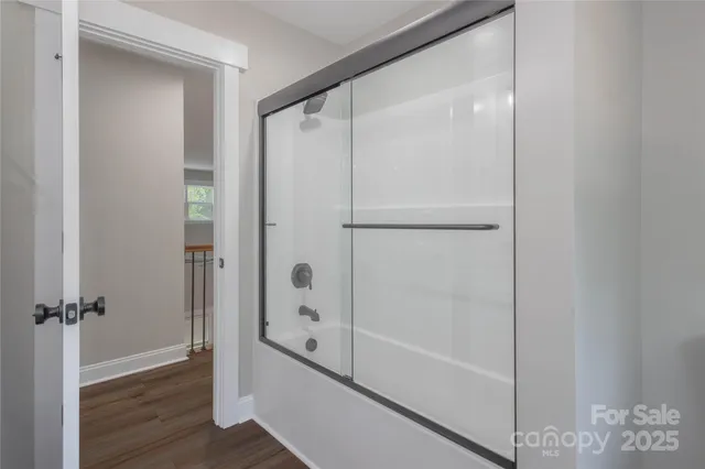 a bathroom with a glass shower door