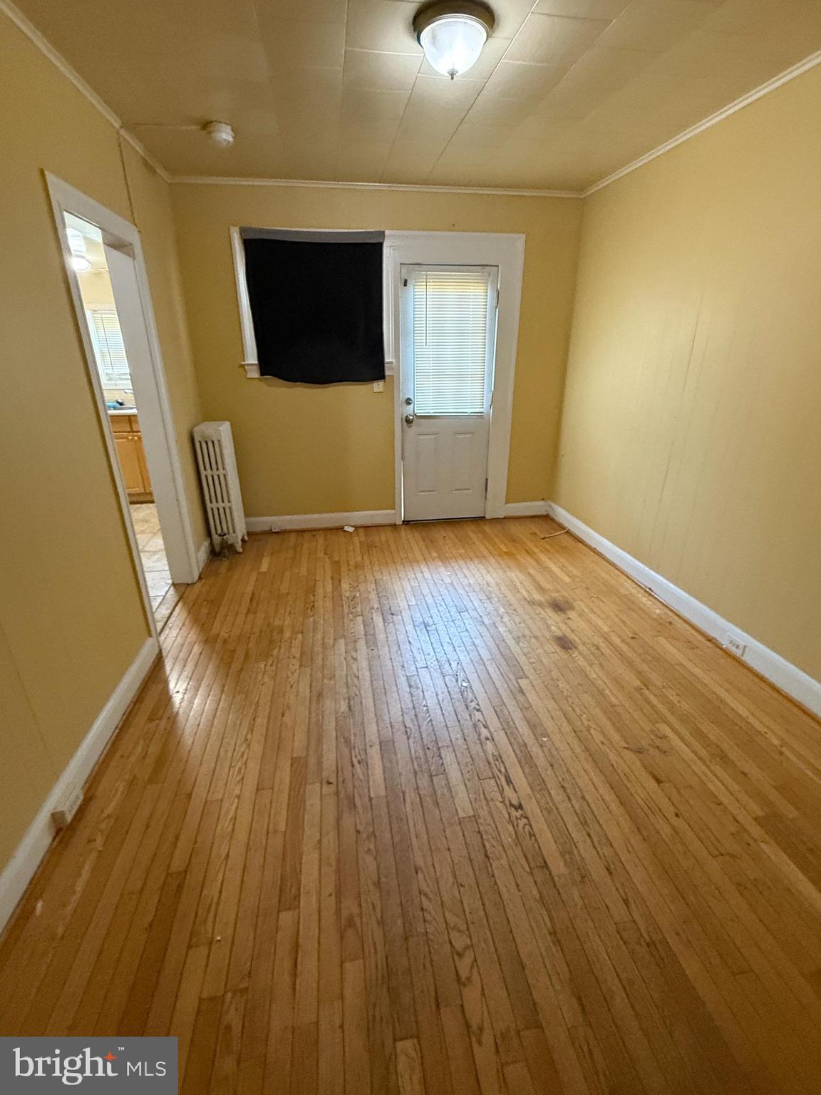 65 Willow Spring Road Baltimore, MD 21222 - Photo 5 of 16 a view of empty room with wooden floor