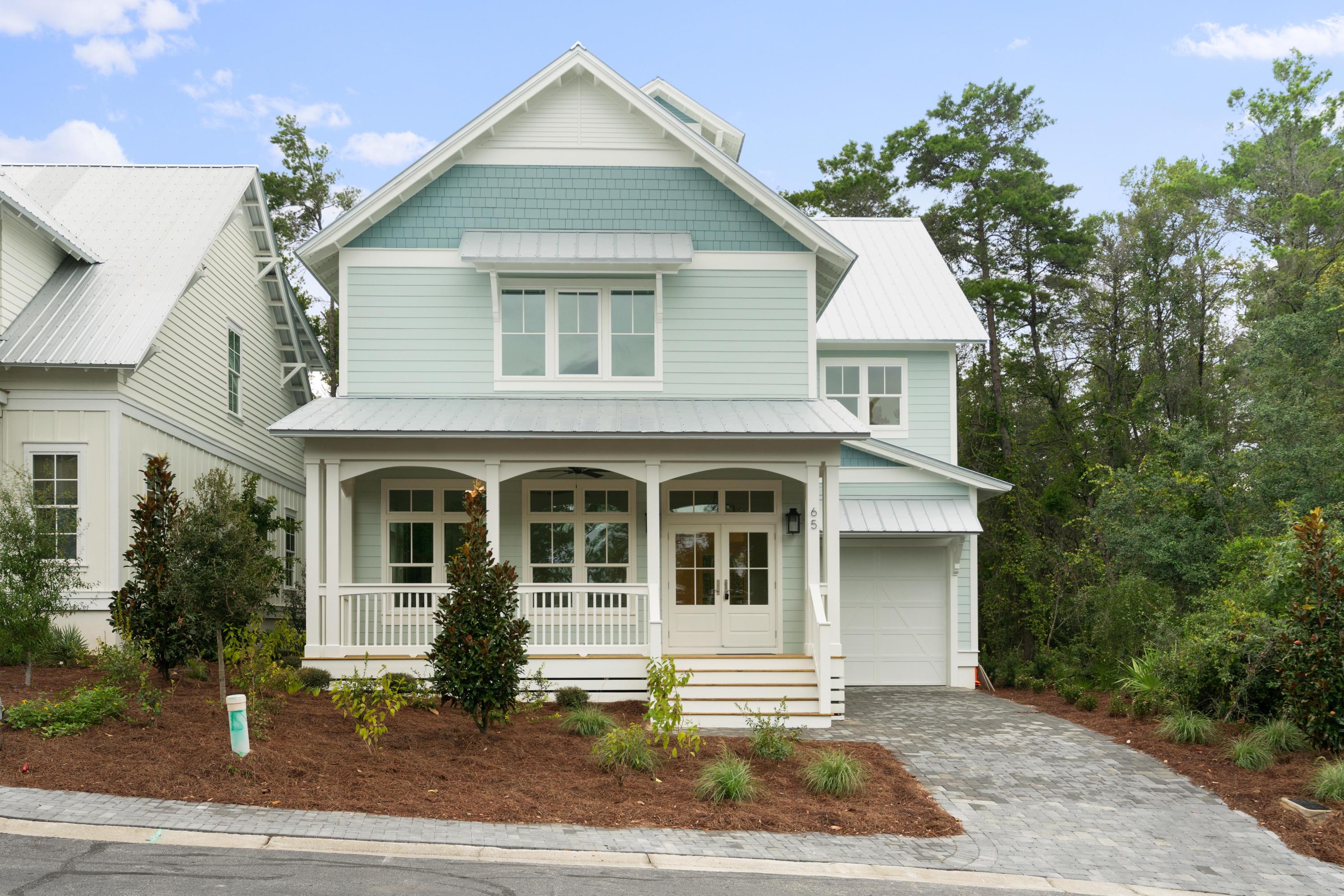 69 Matts Way Way Santa Rosa Beach, FL 32459 - Photo 3 of 37 a front view of a house with a garden