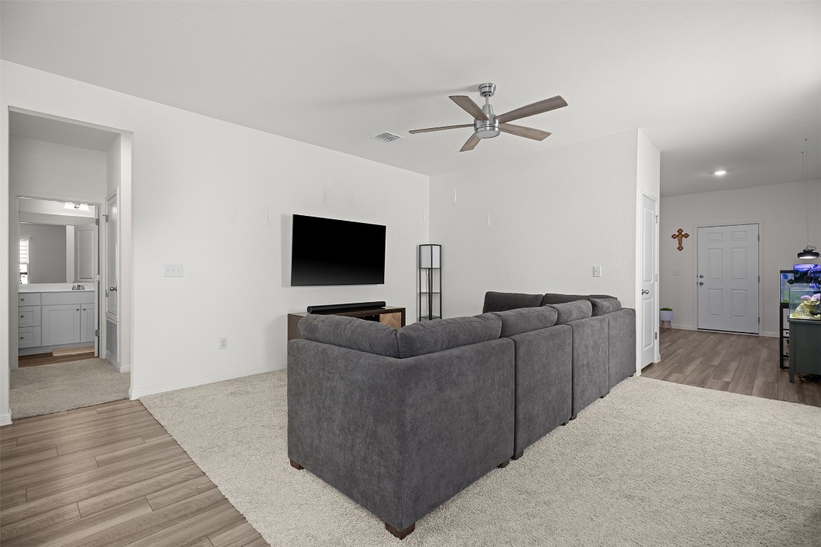 104 Enforcer Loop Jarrell, TX 76537 - Photo 3 of 12 a living room with furniture and a flat screen tv