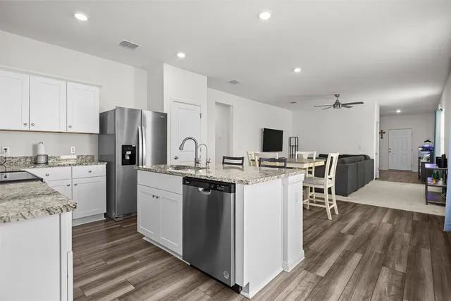 a kitchen with stainless steel appliances a refrigerator stove microwave and cabinets