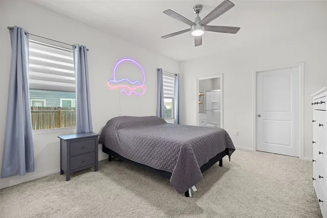 a bedroom with a bed and a large window