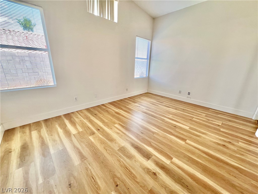 9708 Ridge Creek Place Las Vegas, NV 89134 - Photo 23 of 34 Primary Bedroom, Natural light illuminates the light lvp flooring and high ceilings of this generous interior space.