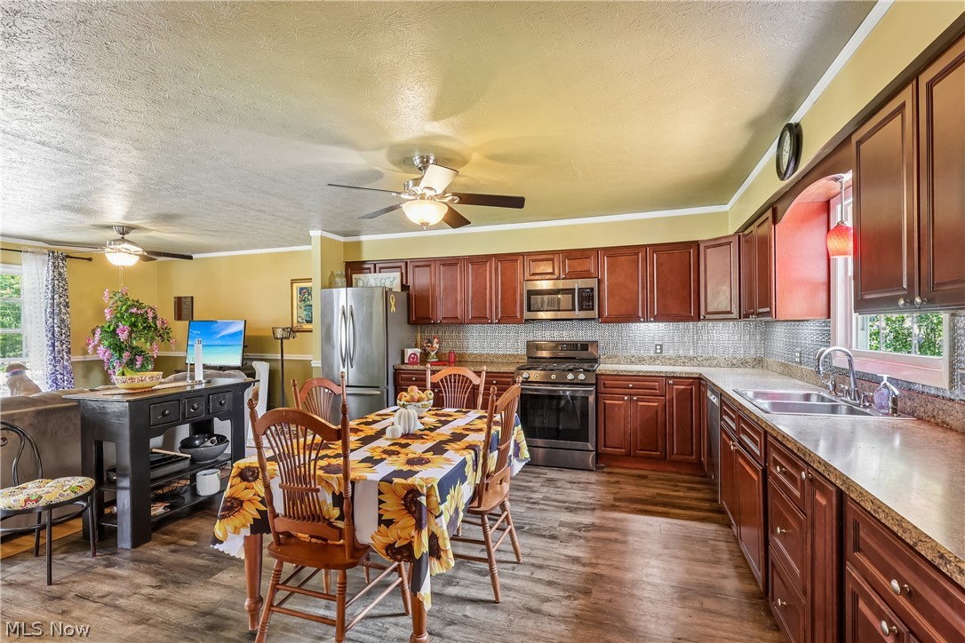 6109 North Oval Road Clinton, OH 44216 - Photo 14 of 47 Kitchen with sink, dishwasher, stove, built-in microwave, refrigerator, ceiling fan / light, and plenty of countertop & cupboard space