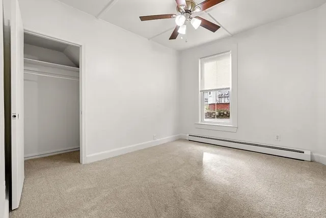 a view of a hallway with wooden floor and entryway
