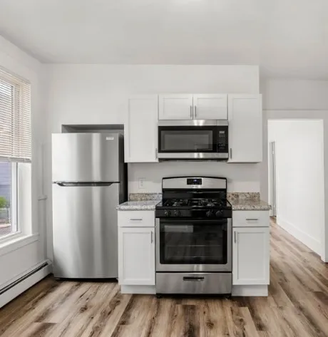 a view of kitchen and wooden floor