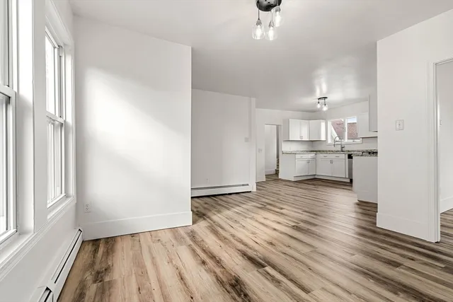 a dining room with wooden floor and furniture