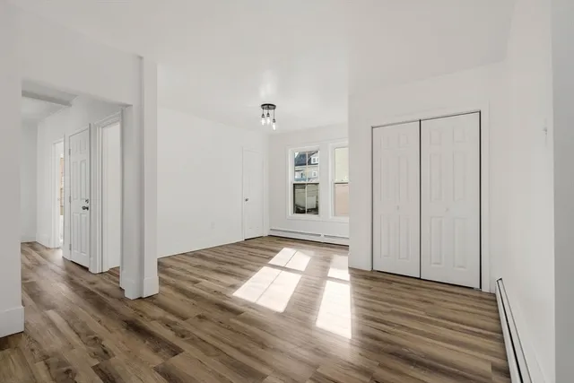 a view of a bathroom with wooden floor and windows