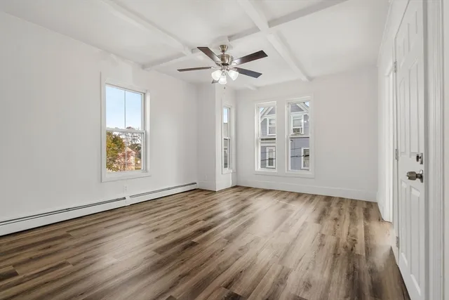wooden floor in an empty room with a window