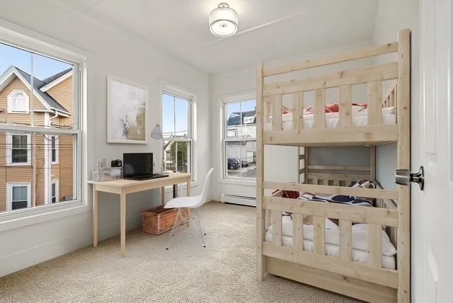 an empty room with chandelier fan