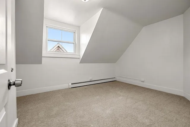 a view of a bench in the garden near a lake
