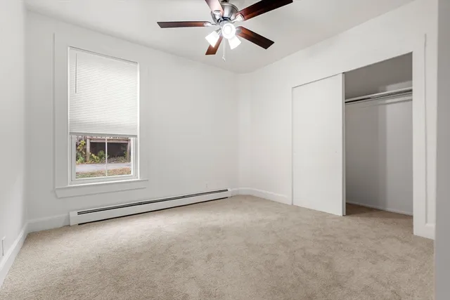 a bed room with a bed and a ceiling fan