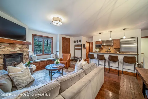 a living room with fireplace furniture and a flat screen tv