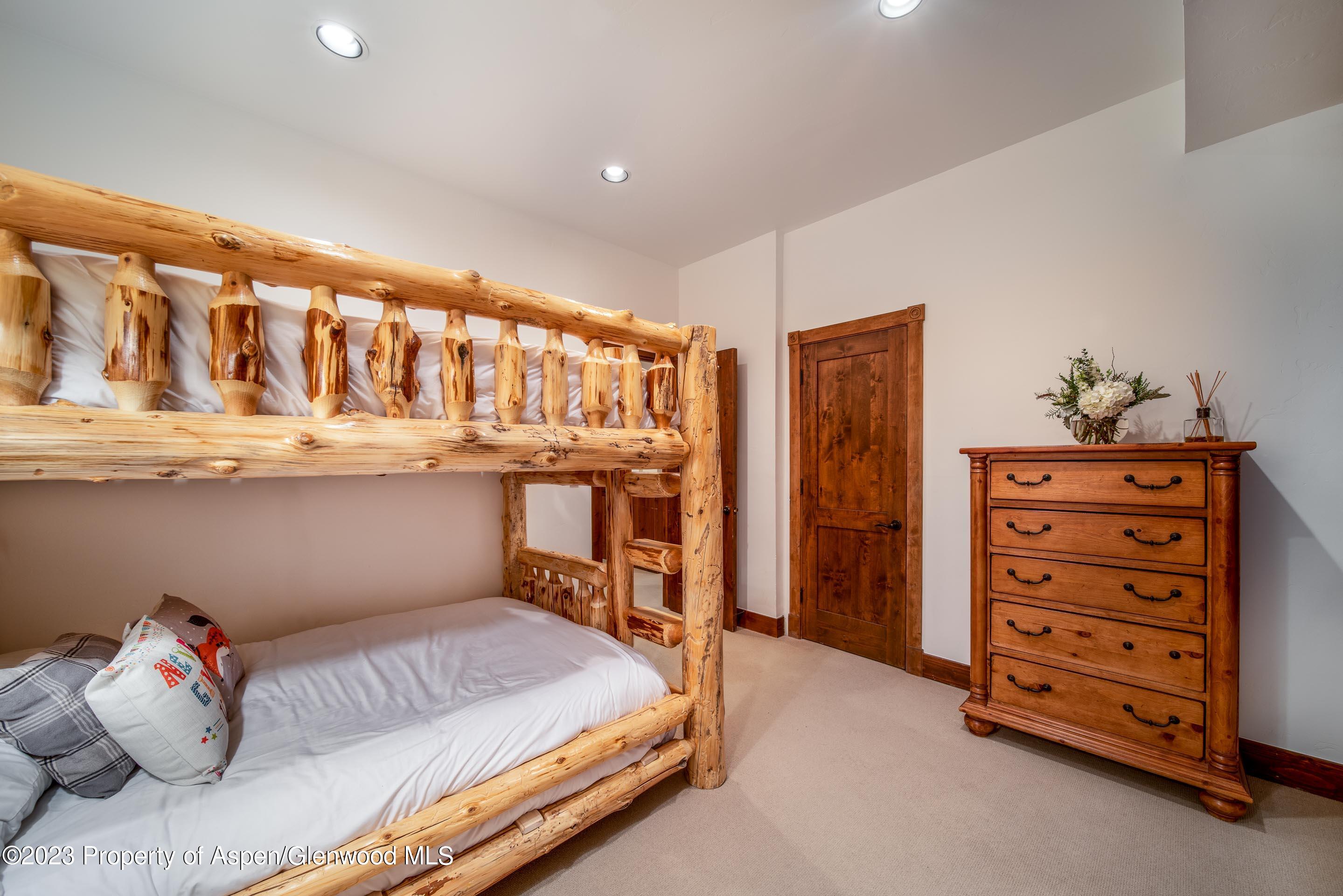 503 West Main Street, Unit B101 Aspen, CO 81611 - Photo 14 of 16 a bedroom with a bed and cabinets