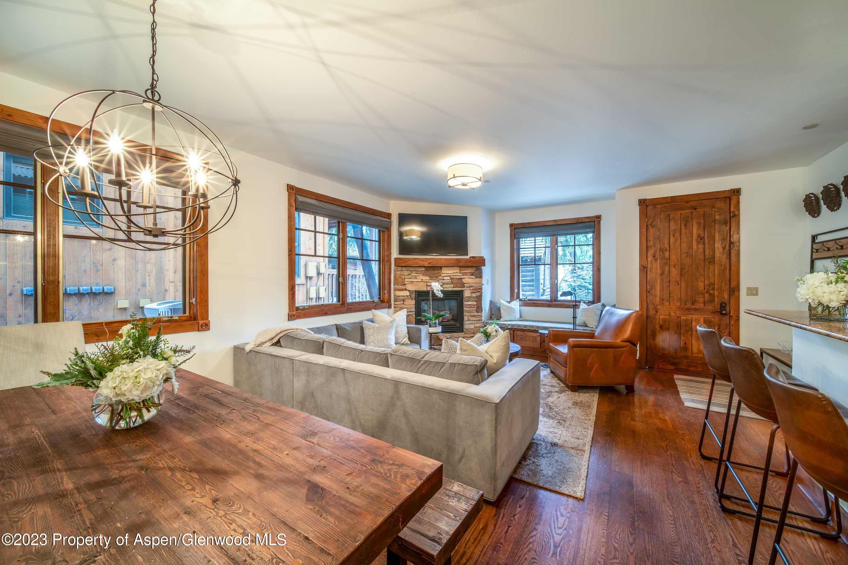 503 West Main Street, Unit B101 Aspen, CO 81611 - Photo 3 of 16 a living room with fireplace furniture and a chandelier