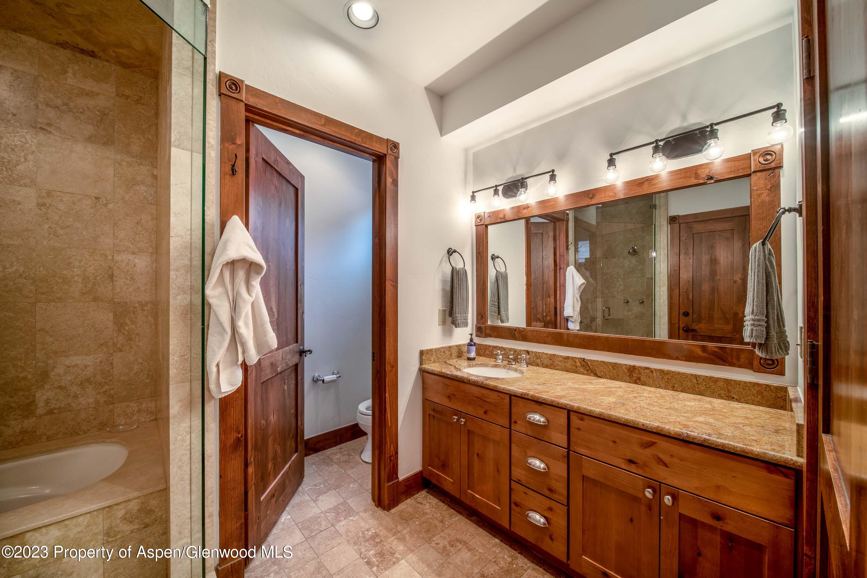 503 West Main Street, Unit B101 Aspen, CO 81611 - Photo 8 of 16 a bathroom with a double vanity sink and mirror with shower