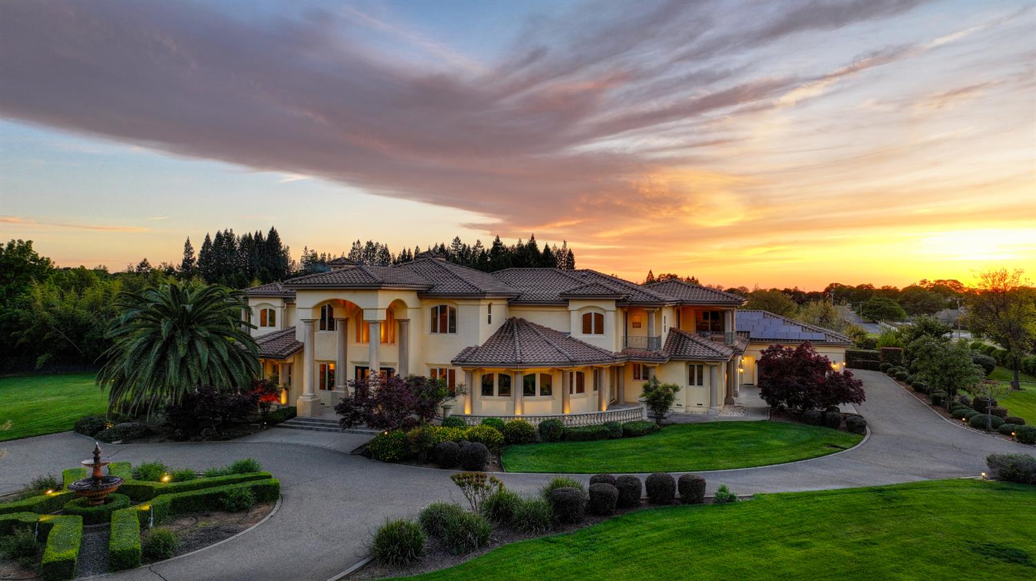 a front view of a house with a garden and a yard