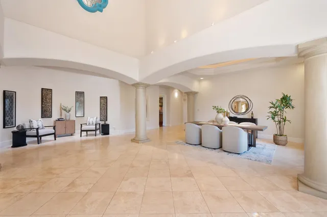 a dining room with furniture potted plants and wooden floor