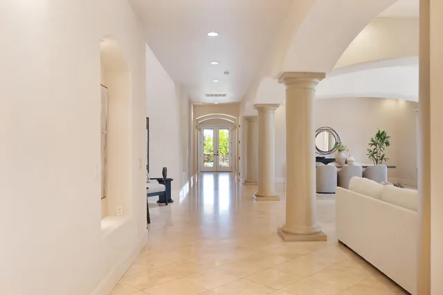 a spacious bathroom with a double vanity sink toilet mirror and bathtub