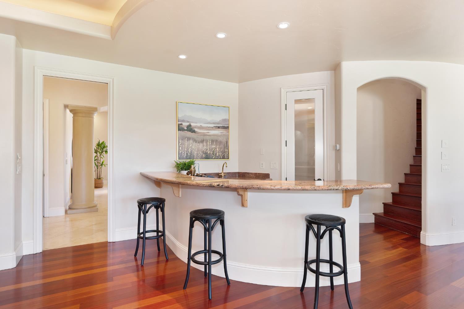 5037 Milton Ranch Road Shingle Springs, CA 95682 - Photo 22 of 99 a kitchen with stainless steel appliances a dining table chairs and wooden floor