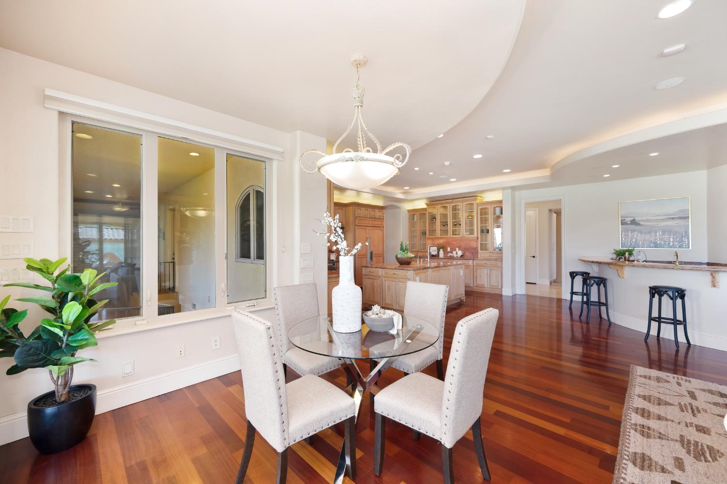 5037 Milton Ranch Road Shingle Springs, CA 95682 - Photo 25 of 99 a dining room with furniture potted plants and wooden floor