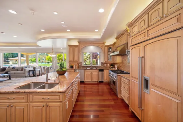 a living room with furniture a flat screen tv and a large window