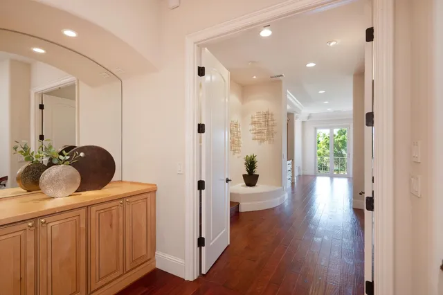 a large bathroom with a tub a sink and a large mirror