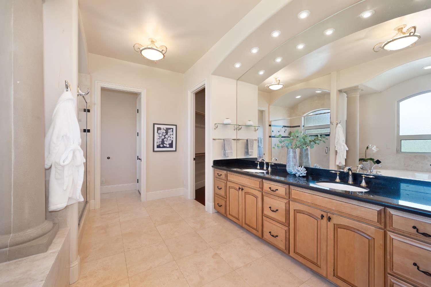 5037 Milton Ranch Road Shingle Springs, CA 95682 - Photo 70 of 99 a large kitchen with stainless steel appliances a large counter top a sink and a refrigerator