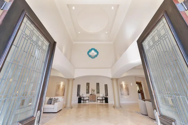 a dining room with furniture and a floor to ceiling window