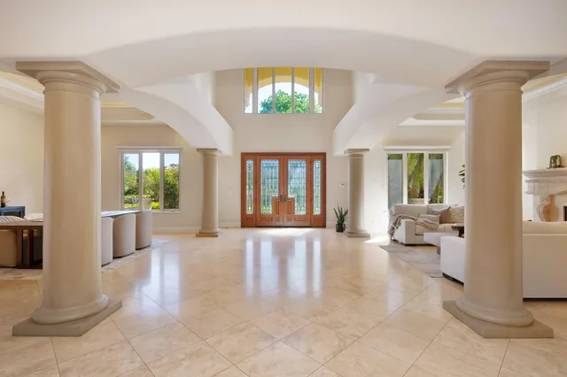 a kitchen with stainless steel appliances a dining table chairs and wooden floor