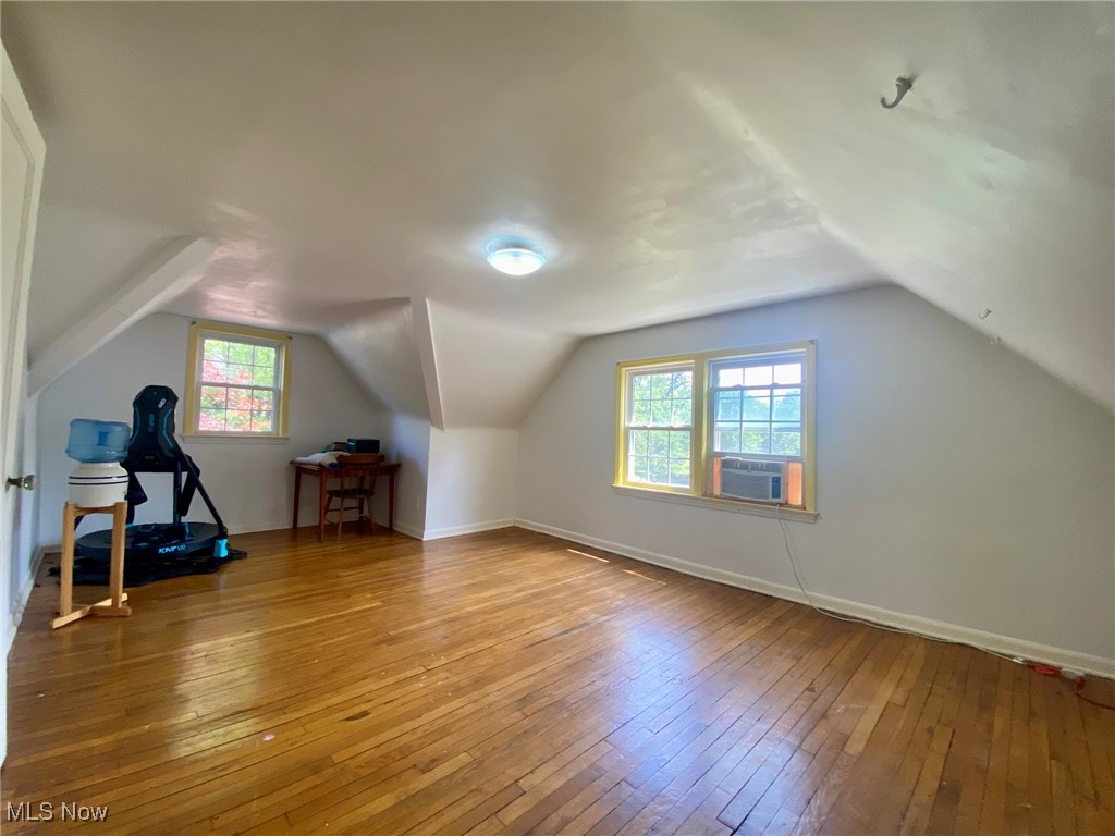 1568 Sunview Road Cleveland, OH 44124 - Photo 27 of 50 Additional living space featuring hardwood / wood-style flooring, vaulted ceiling, and cooling unit