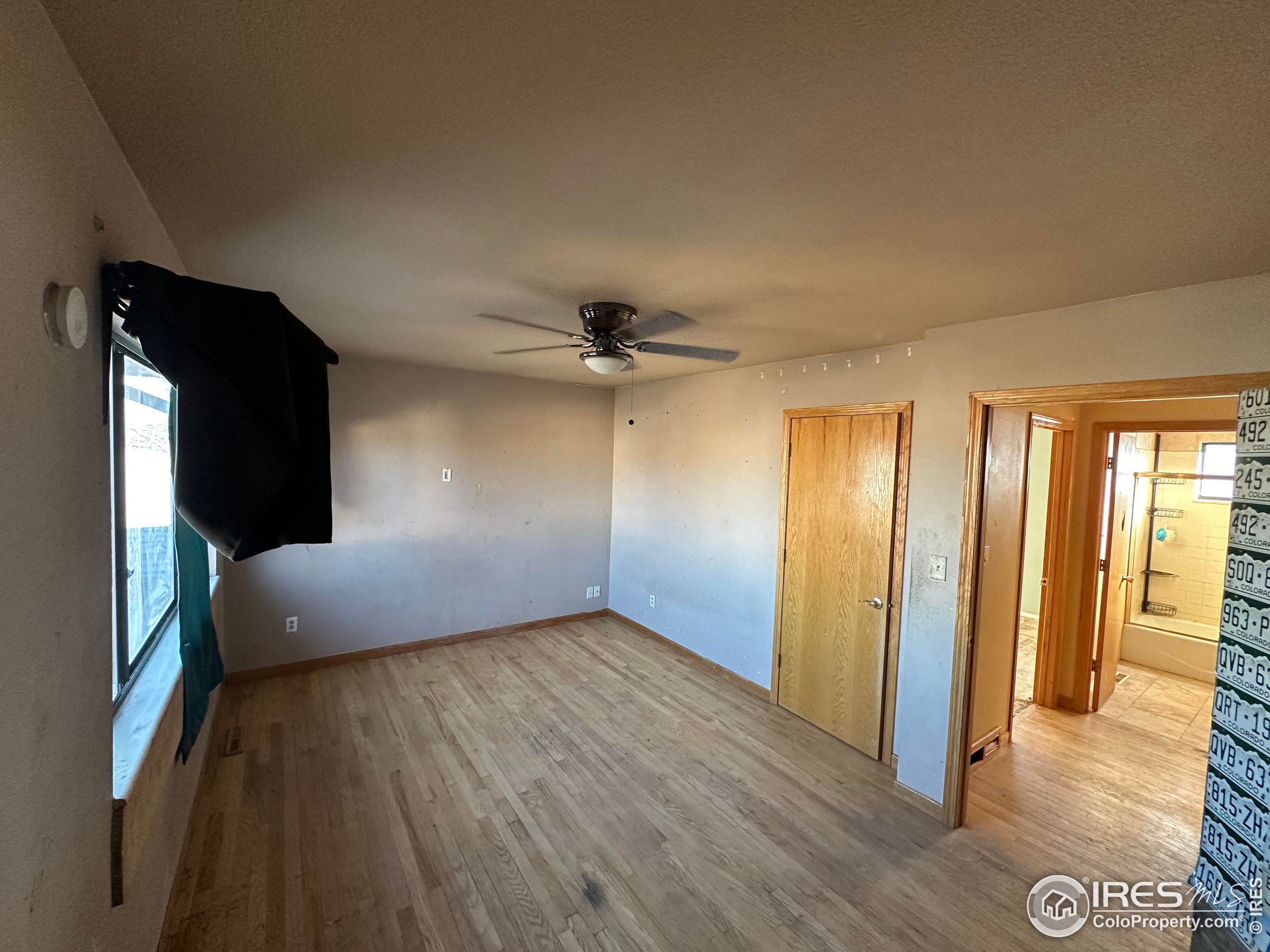 832 21st Street Southwest Loveland, CO 80537 - Photo 11 of 15 wooden floor in an empty room with a window